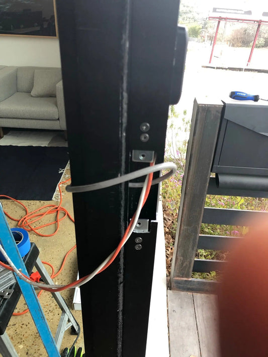 Brivo cloud access control dashboard on a laptop with a phone-based mobile credential unlocking an office door, deployed by Avenger Security.